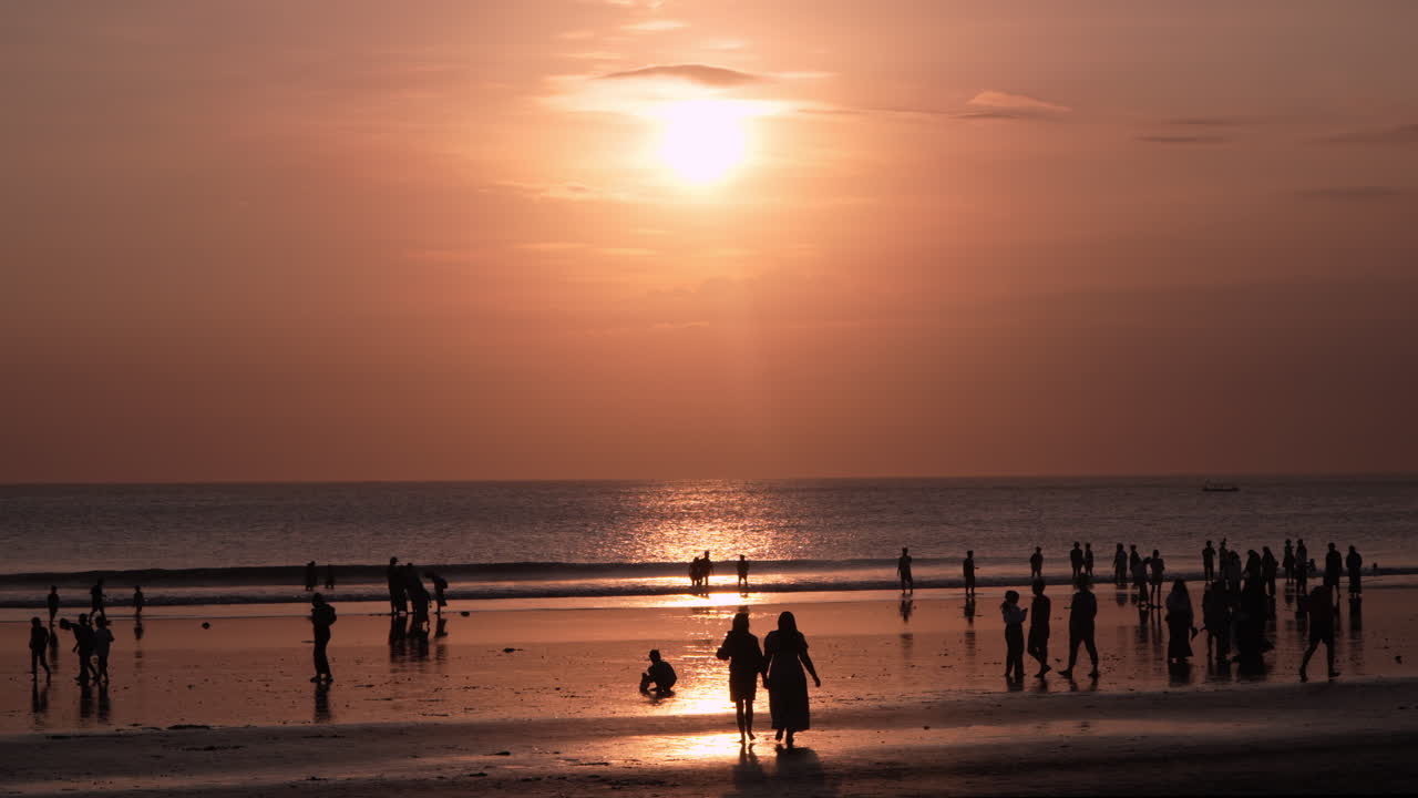 Silhouetted People Enjoying Sunset on Tropical Beach