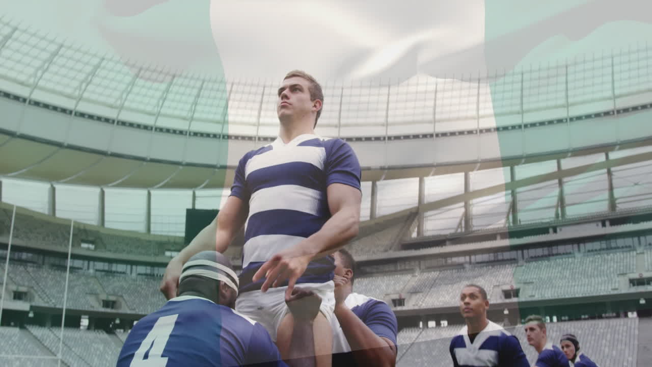 Holding ball in stadium, rugby player being lifted by teammates during game