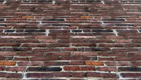 a close-up pedestal camera shot of an old red brick wall - seamless looping