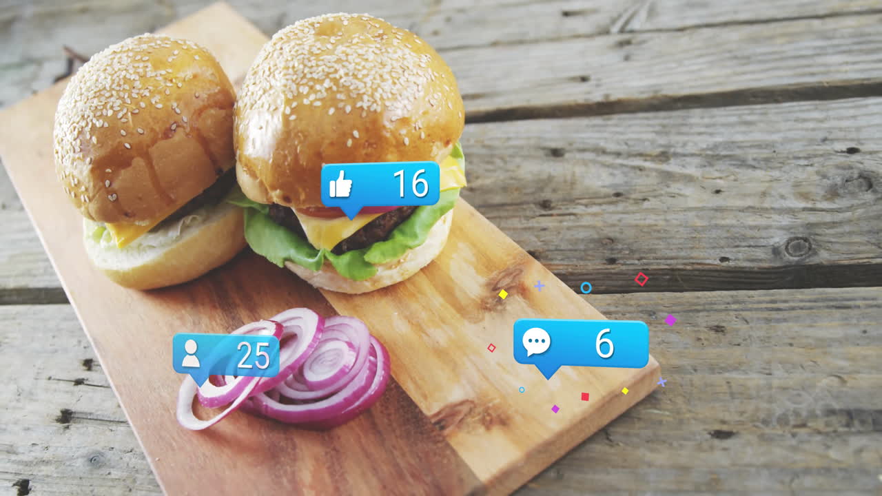 Burgers with animation of social media like and comment icons on wooden board