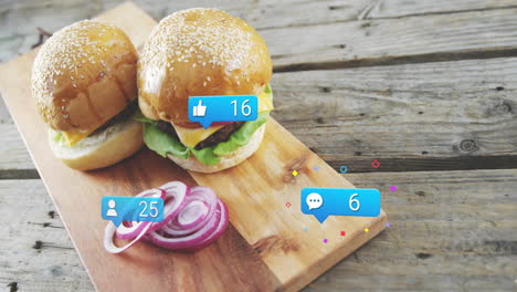 burgers with animation of social media like and comment icons on wooden board