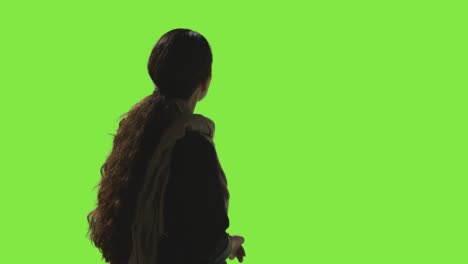 low key studio shot of woman looking all around frame against green screen in vr environment 1