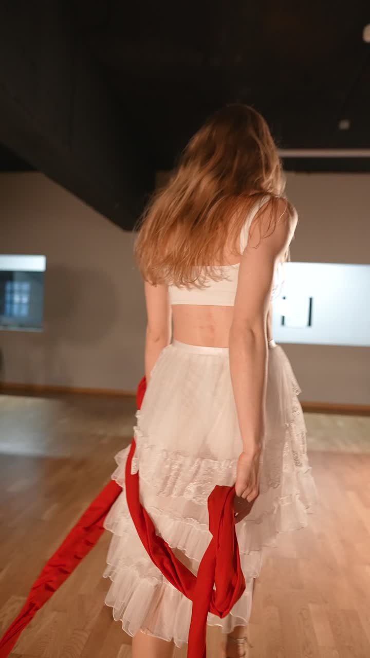 Woman Performing Contemporary Dance with Red Ribbons