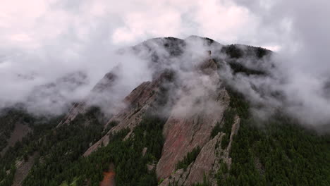 flatirons surrounded dramatically by mountain fog, chautauqua park