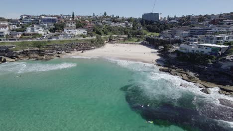 waves crashing on rocky coastline of beach in tamarama on a sunny summer day in australia