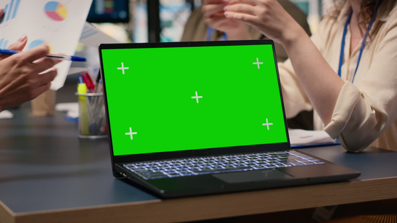 Team of businesswomen creates a strategy next to chroma key display