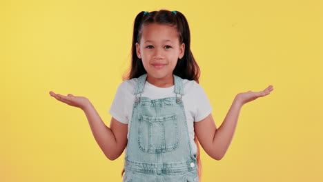 Girl in overalls shrugging