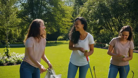 women volunteering in a park cleanup
