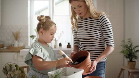 video of girl putting soil in a compost.