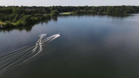 aerial of an adventurist, enjoying water skiing in the calm waters of lake menomin, menomonie, wi, usa