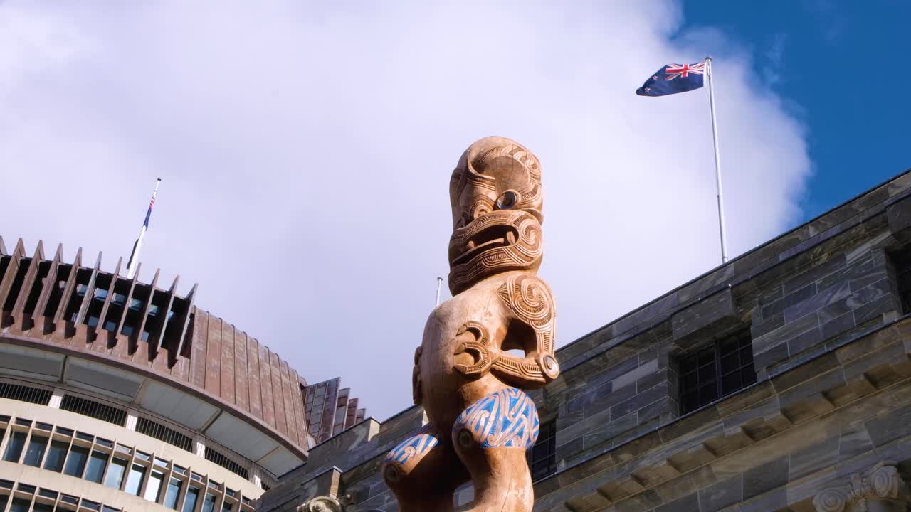 View of cultural Maori Te Kāhui Mōuri taonga outside the Beehive Parliament buildings in capital city of Wellington NZ Aotearoa