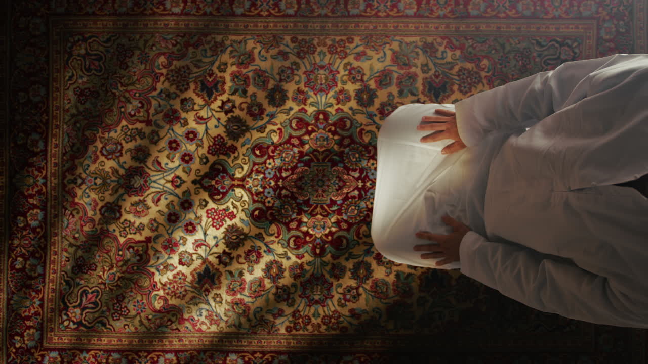 Young Man Praying On Carpet For Ramadan