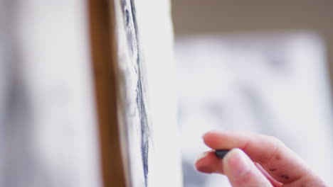 Close-Up-Of-Artist-Sitting-At-Easel-Drawing-Picture-Of-Dog-In-Charcoal