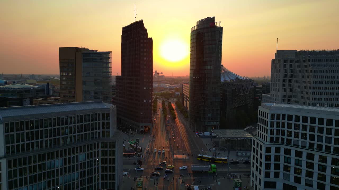 Berlin potsdamer platz skyline during golden hour sunset with traffic flowing on roads. Majestic aerial view flight static tripod hovering drone