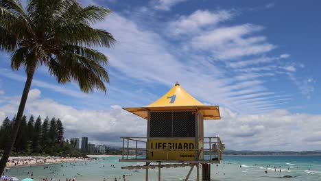 lifeguard hut on a busy beach with swimmers