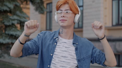 Young Man Listening to Music and Dancing on the Street
