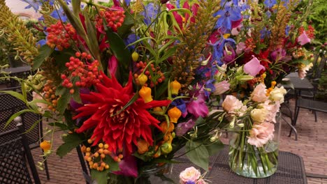 colourful wedding flowers in clear vases on table