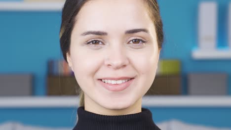 Young-woman-with-white-and-shiny-teeth-smiles.