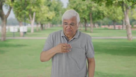 Sick-Indian-old-man-suffering-from-cold-and-cough-in-park