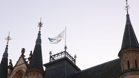 scottish-flag-waving-above-the-peoples-government-palace-along-high-street-in-Inverness,-Scotland-in-the-Highlands