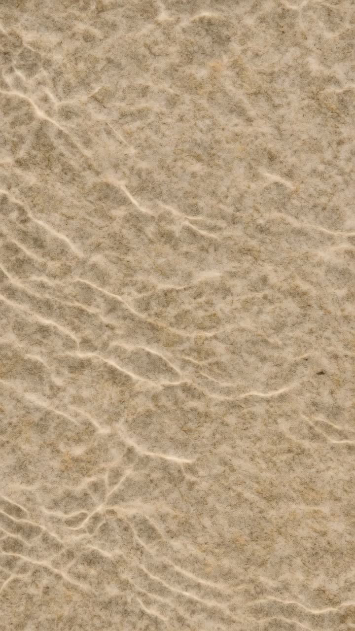 Close-up, textured beige paper background, perfect for video backdrops