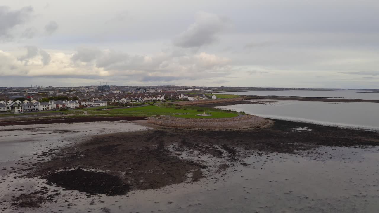 dolly aéreo a salthill vista por la playa de grattan en la marea baja en la bahía de galway irlanda