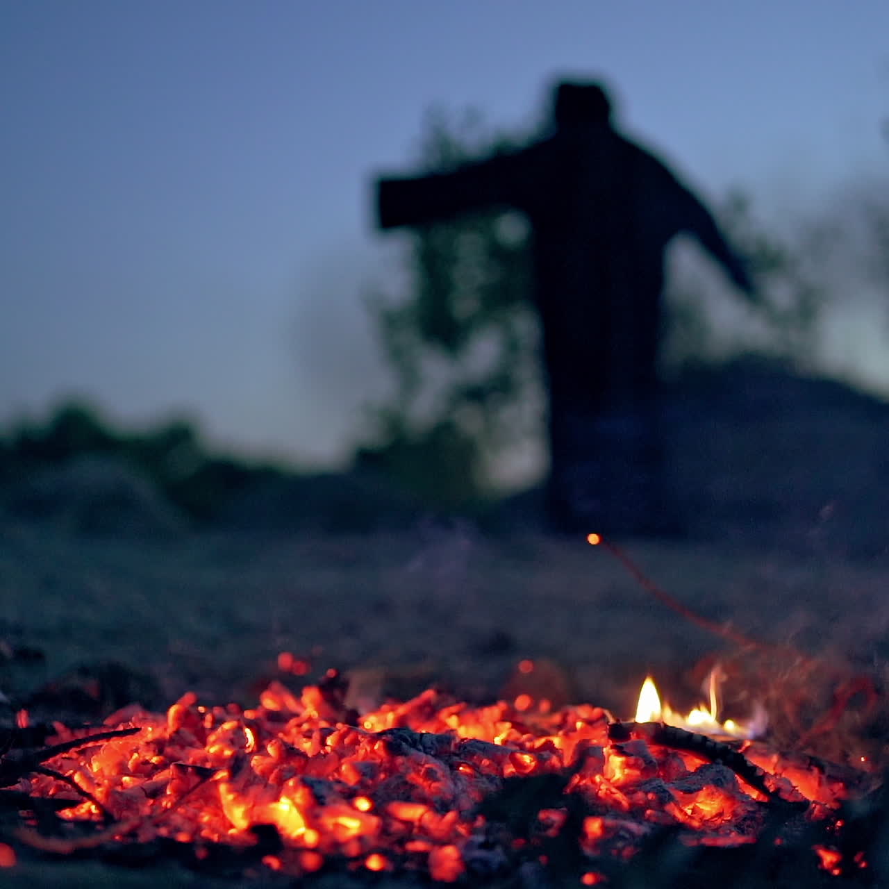 Glowing coals after flame on blurred background with death. Horrible atmosphere of ghost in black at night. Halloween.
