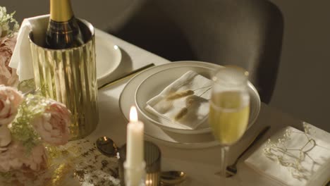 table set for meal at wedding reception with champagne in ice bucket 7