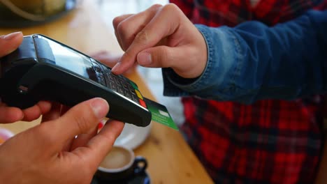 customer paying by credit card in restaurant