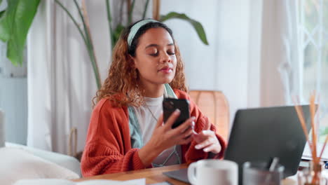 woman working from home on a laptop and talking on the phone