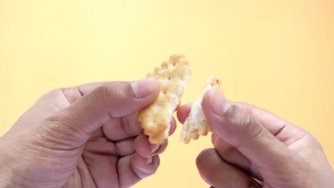 broken cracker in hands