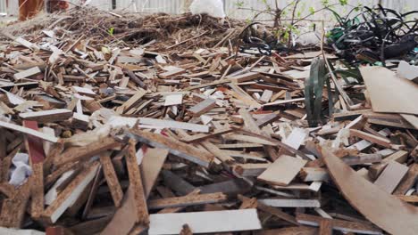production waste in the yard. heaps of rubbish, chipboard fragments, plastic bands. environmental pollution