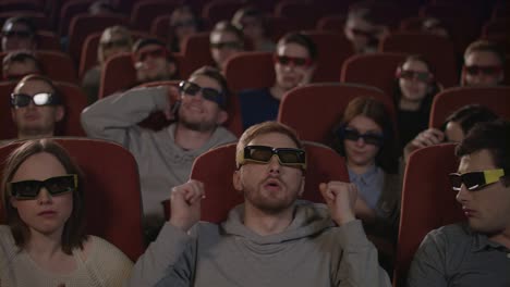 man talking on phone in cinema. man speaking mobile phone and disturb people