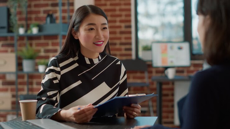 Female recruiter interviewing woman with work experience on cv