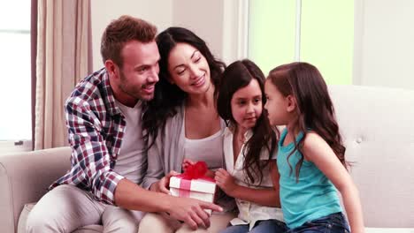 girls offering gift to their mother