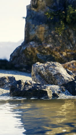 nature landscape with rocky shore and calm water during the day