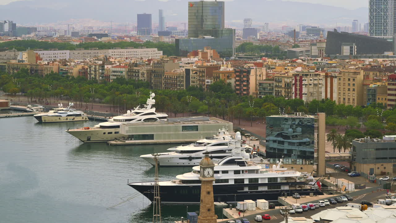 Barcelona, Spain - June 22, 2021: Aerial drone view of boats docked in the Port Vell