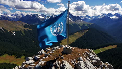 united nations flag on mountain peak