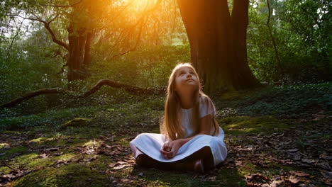young girl sits peacefully in a sunlit enchanted forest
