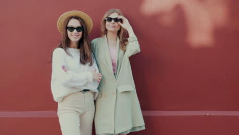 two women posing in trendy outfits