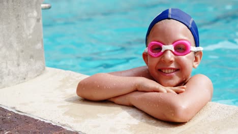 Smiling-boy-leaning-at-poolside