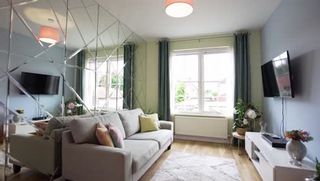 a modern living room with stylish décor featuring a cozy sofa, elegant lighting, and beautiful greenery for a welcoming atmosphere in an inviting space