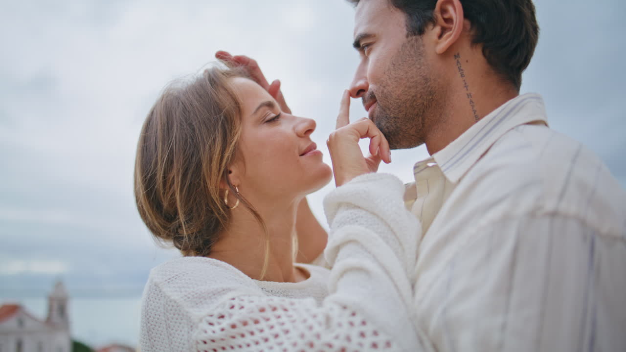 Love couple touching faces at seascape date closeup. Loving sexy pair enjoying