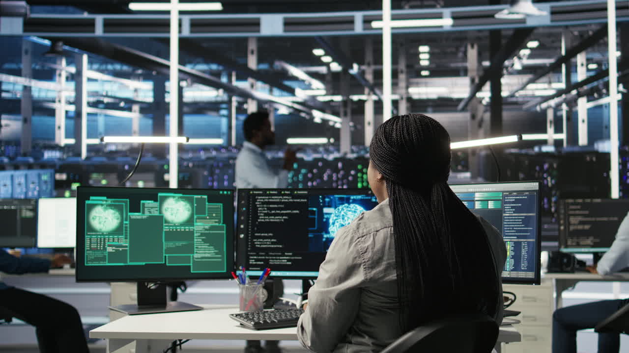 Server farm IT expert responds to security breach alert displayed on PC monitor