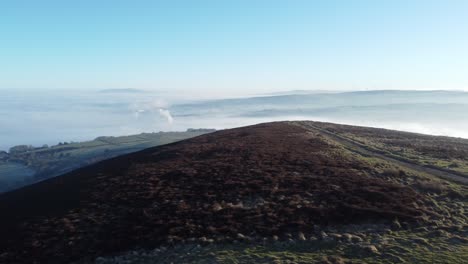 Cloudy-misty-sunrise-valley-aerial-moorland-hiking-hillside-muddy-path-Lancashire-dolly-right