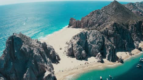 incredibly gorgeous aerial drone panoramic of an exotic rocky sandy beach with striking blue water