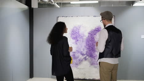 couple viewing abstract art in an art gallery