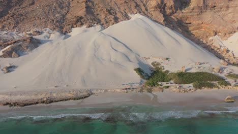 aerial view of a stunning beach with sand dunes and campers