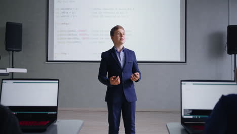 boy giving a presentation about coding to a class