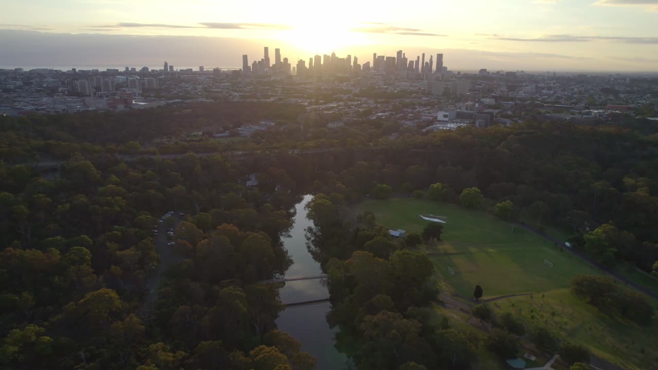 Vista aerea al tramonto del fiume Yarra in primo piano e dello skyline della città di Melbourne sullo sfondo, Victoria, Australia. Dicembre 2025